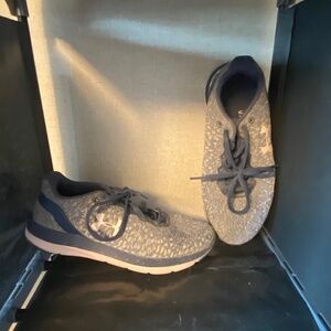Pink and blue under armor running shoes
